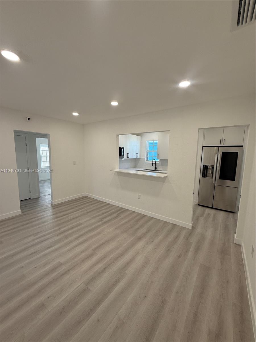 4020 Northwest 12th Avenue Miami, FL 33142 - Photo 9 of 13 a view of a livingroom with wooden floor