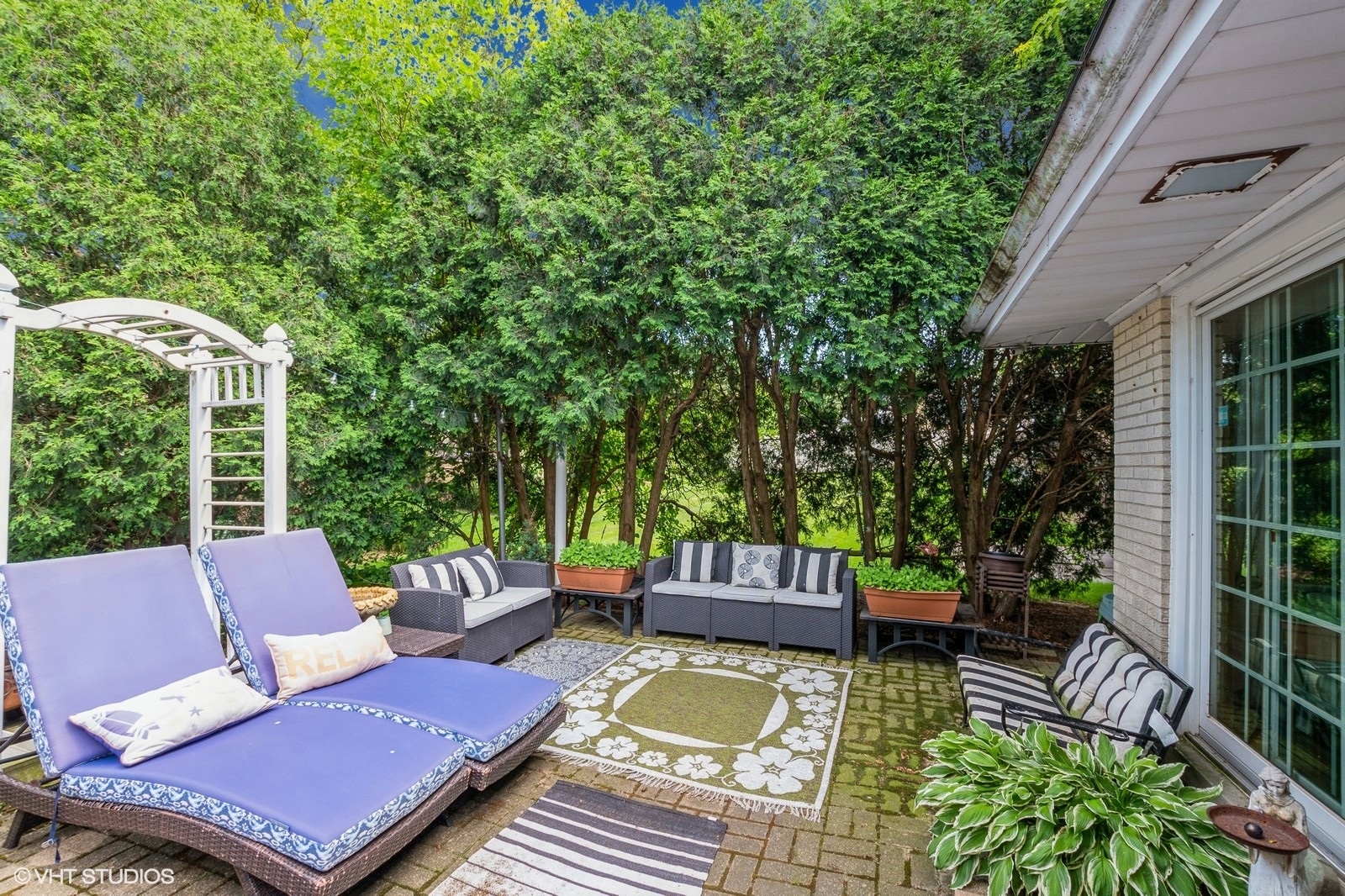 13011 South Shawnee Road Palos Heights, IL 60463 - Photo 25 of 28 a view of a patio with couches table and chairs and potted plants
