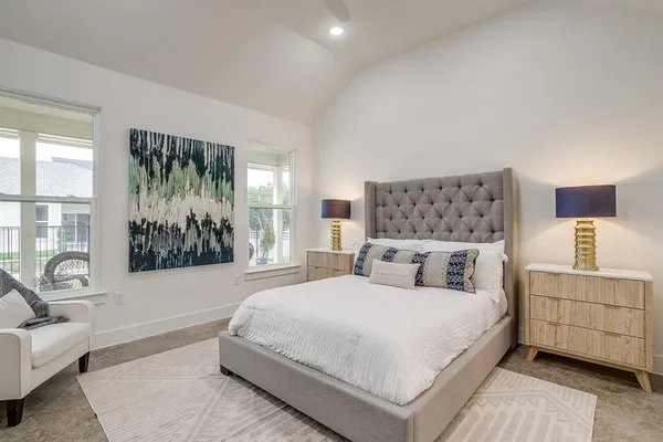 a bedroom with a large bed couch and a window