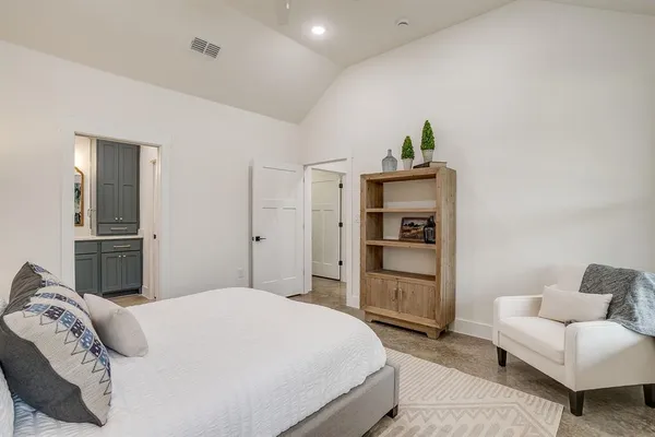 a bedroom with a bed and a couch