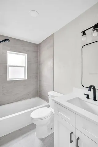 a bathroom with a sink a toilet and bathtub