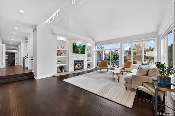 a living room with fireplace furniture and a large window