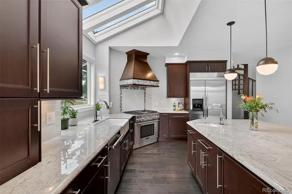 a kitchen with stainless steel appliances granite countertop sink stove top oven and microwave