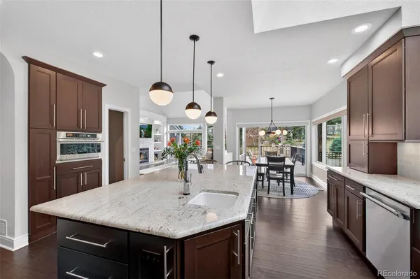 a kitchen with counter space dining table and stainless steel appliances