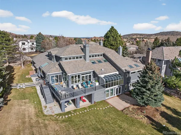 an aerial view of a house with a big yard and large trees