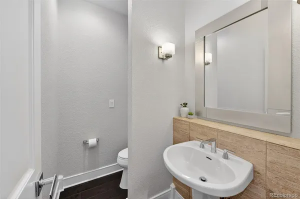 a bathroom with a sink a toilet and a mirror