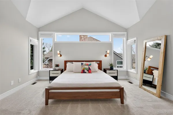 a bedroom with a bed and a mirror