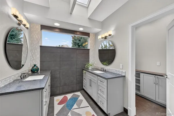a bathroom with a sink a vanity and mirror