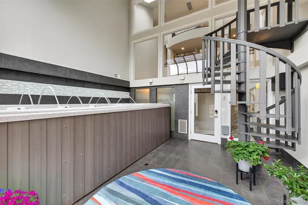 a view of staircase with white walls and a window