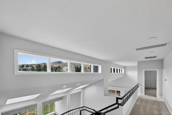 a view of staircase with white walls and a window