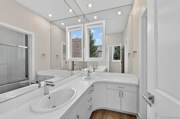 a bathroom with a granite countertop sink mirror and vanity