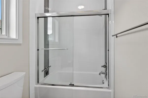 a living room with furniture pool table flat screen tv and windows