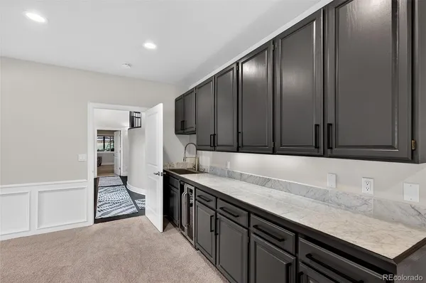 a balcony with wooden floor and barbeque oven in the back