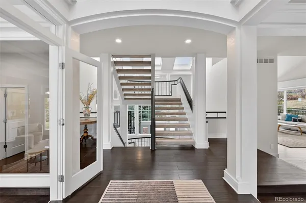 a view of entryway and hall with wooden floor