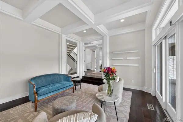 a living room with furniture and flowers