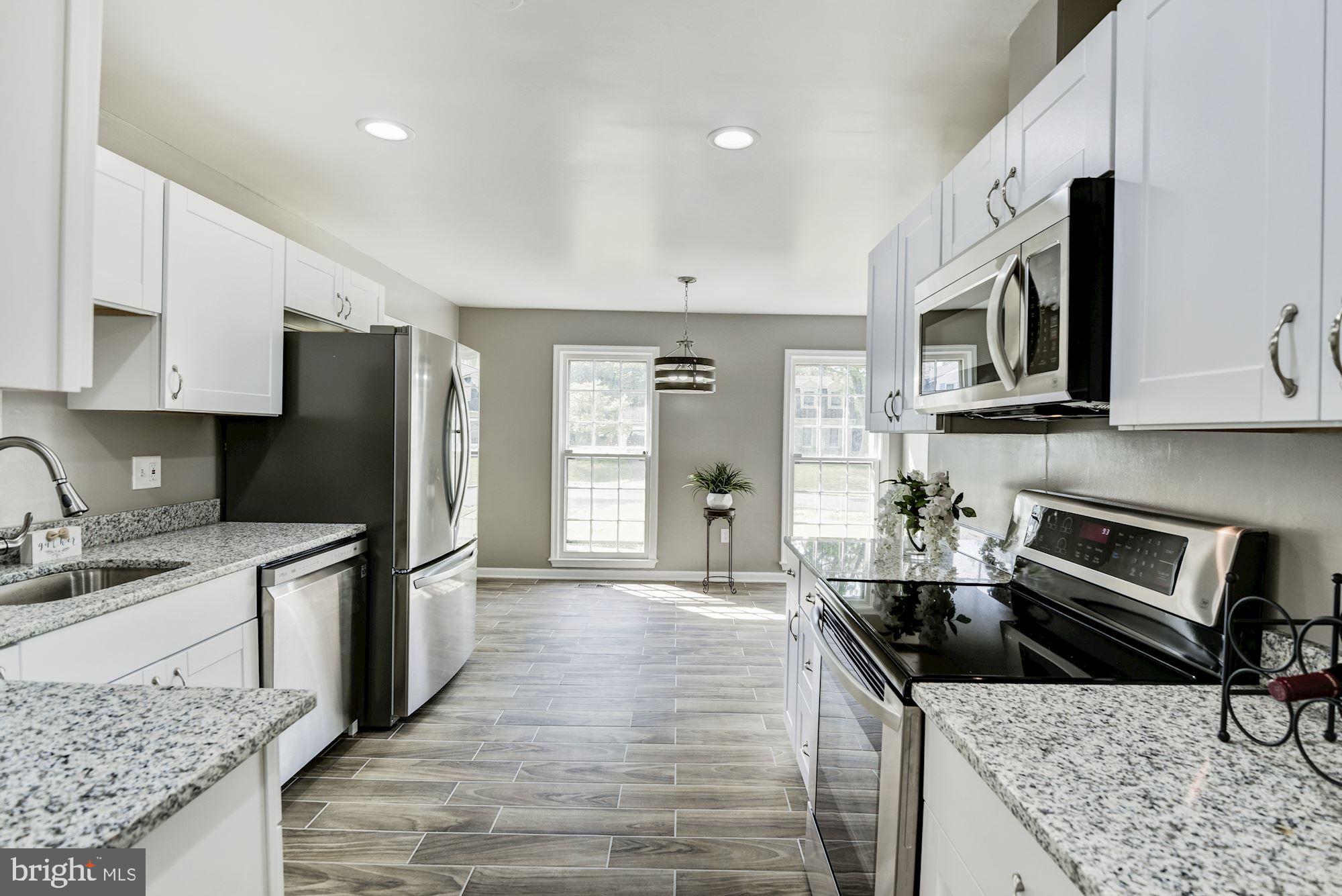 15020 Wellwood Road Silver Spring, MD 20905 - Photo 13 of 38 New kitchen, granite, stainless, tile floor.