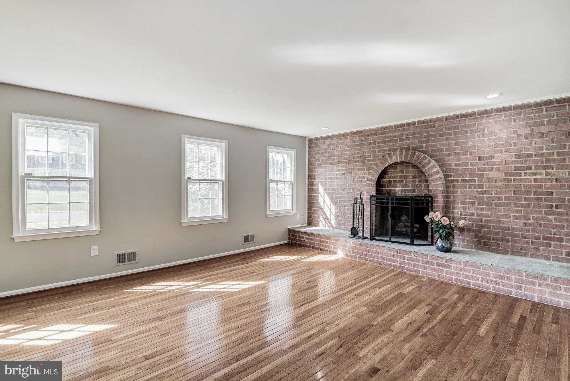 15020 Wellwood Road Silver Spring, MD 20905 - Photo 15 of 38 Fireplace with brick hearth, recessed lights.