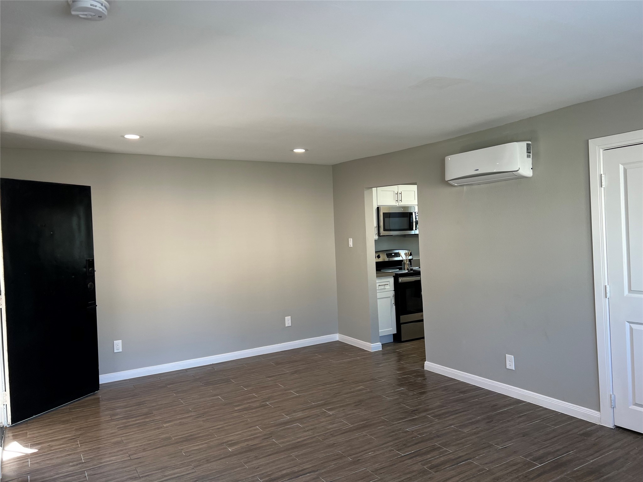 2017 Buffalo Terrace, Unit 15 Houston, TX 77019 - Photo 3 of 9 wooden floor in an empty room with a window