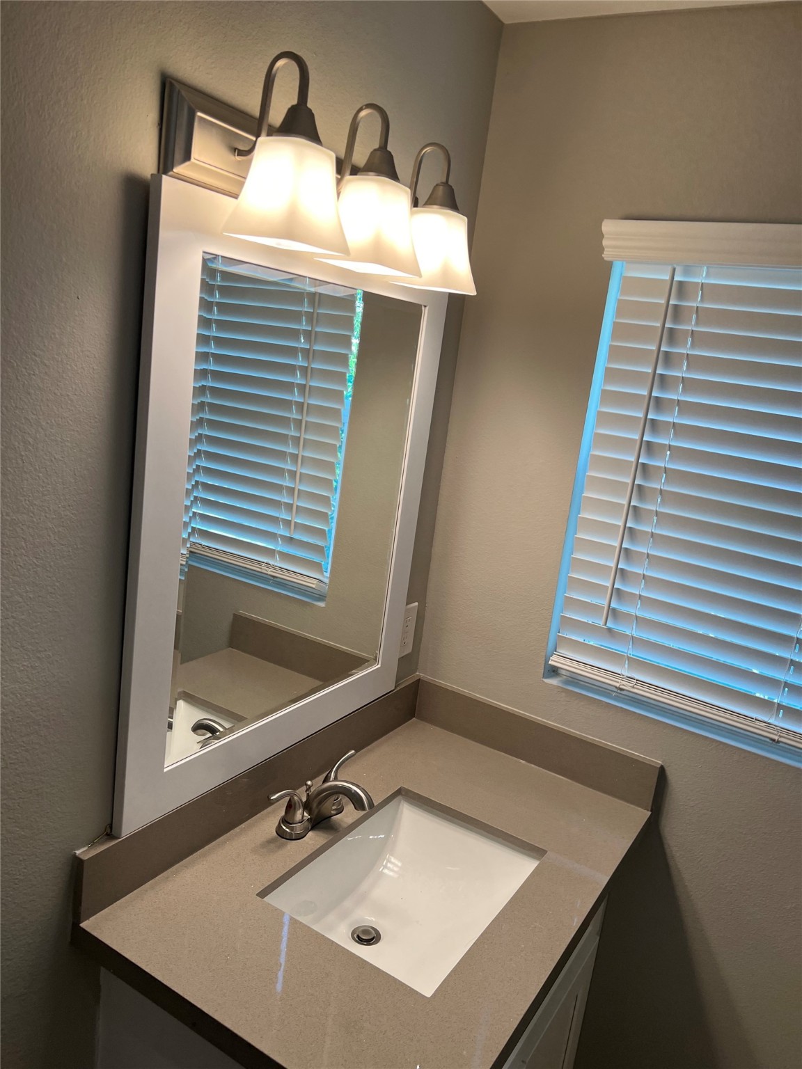 2017 Buffalo Terrace, Unit 15 Houston, TX 77019 - Photo 4 of 9 a bathroom with a sink and a mirror