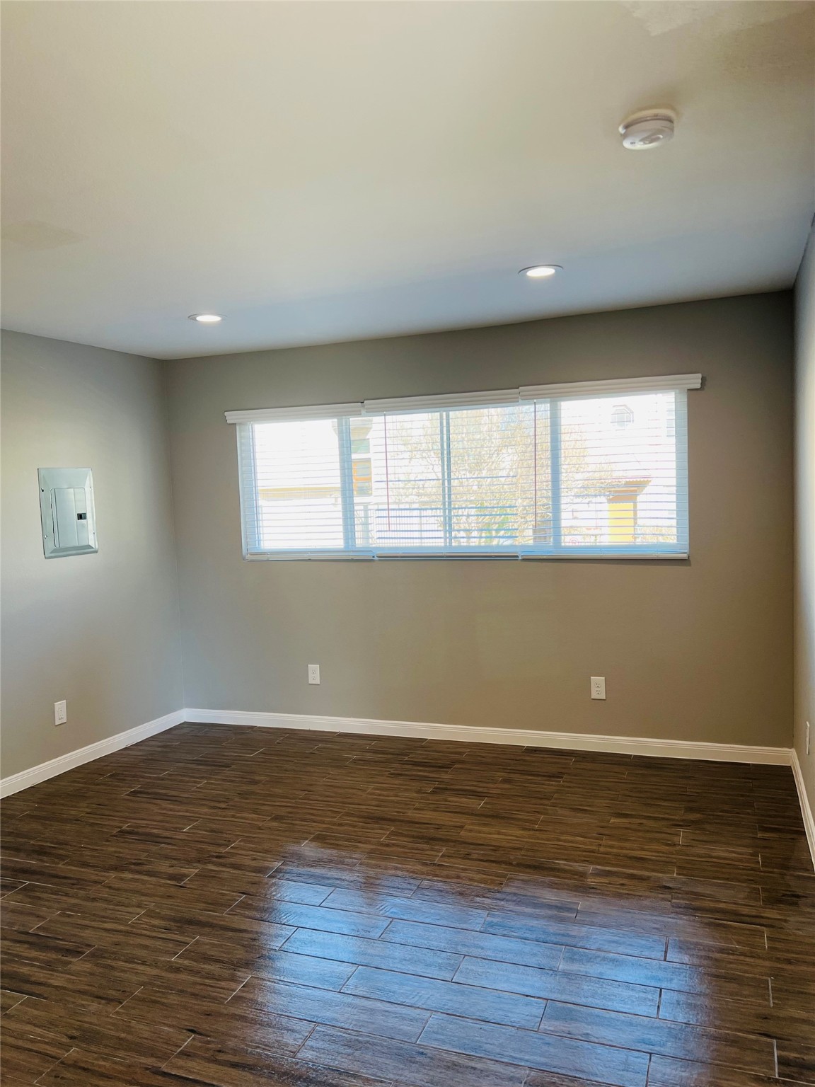 2017 Buffalo Terrace, Unit 15 Houston, TX 77019 - Photo 6 of 9 a view of an empty room with wooden floor and a window