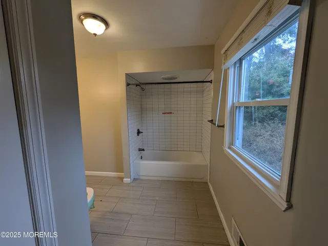 a bathroom with a bathtub and shower