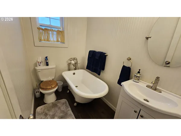 a bathroom with a toilet a sink and mirror