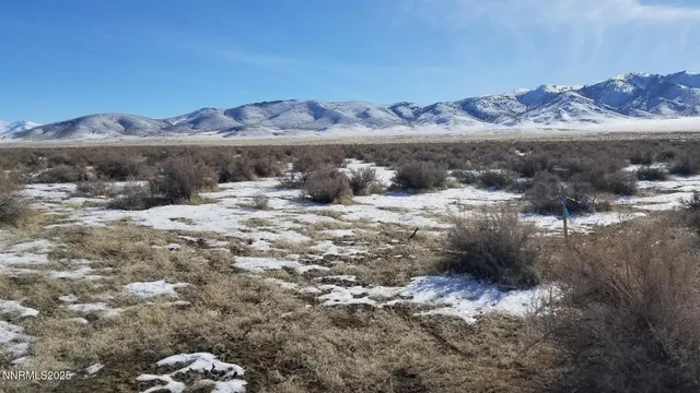 a view of a town with mountains in the background