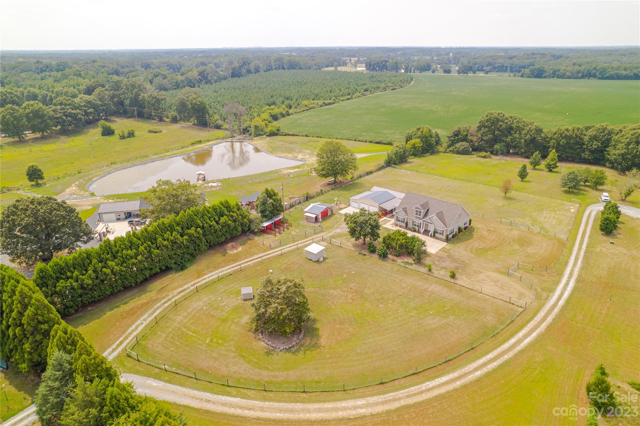 1131 Sikes Mill Road Monroe, NC 28110 - Photo 17 of 43 a view of a swimming pool with a table and chairs