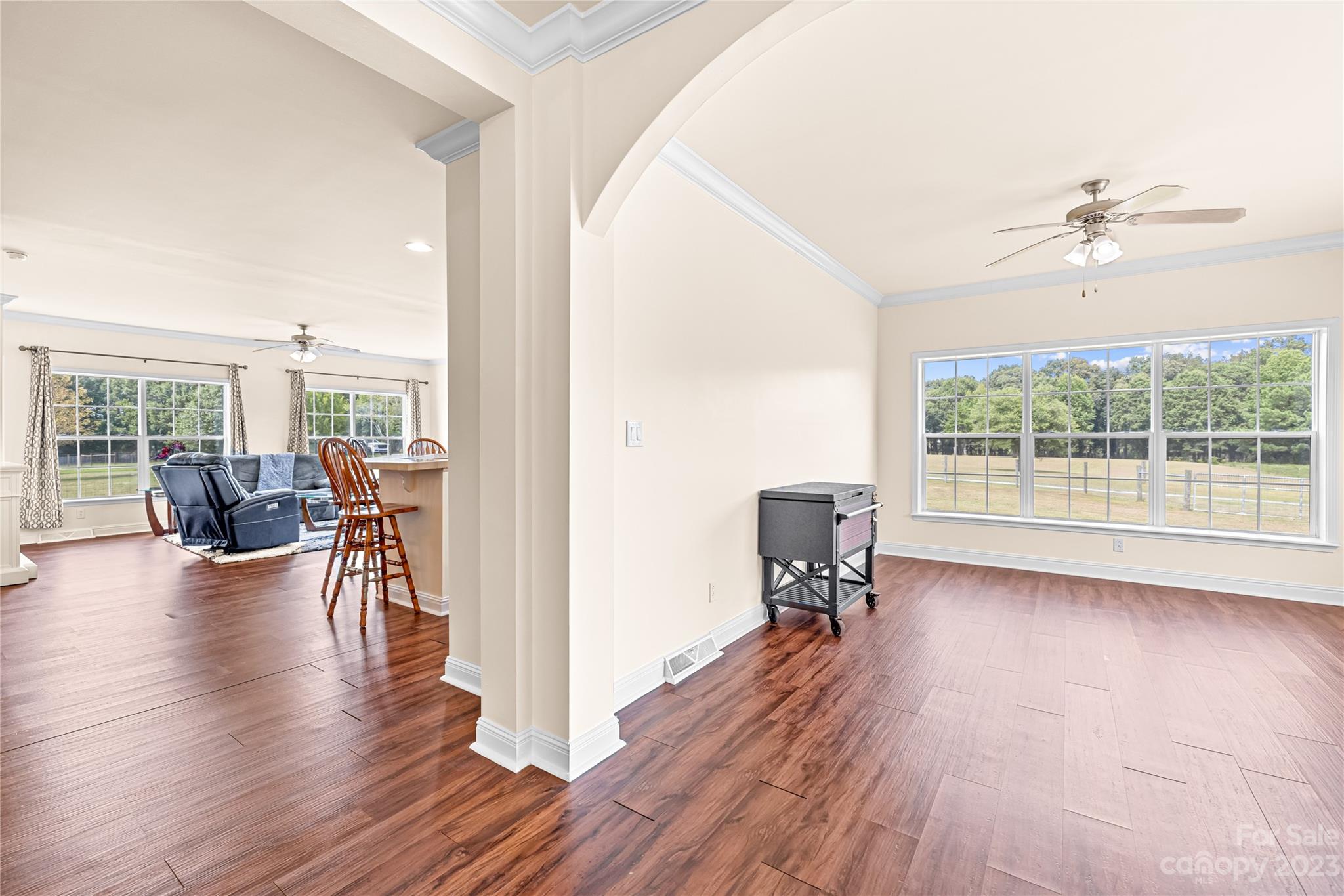 1131 Sikes Mill Road Monroe, NC 28110 - Photo 22 of 43 a view of a livingroom with furniture a ceiling fan and wooden floor
