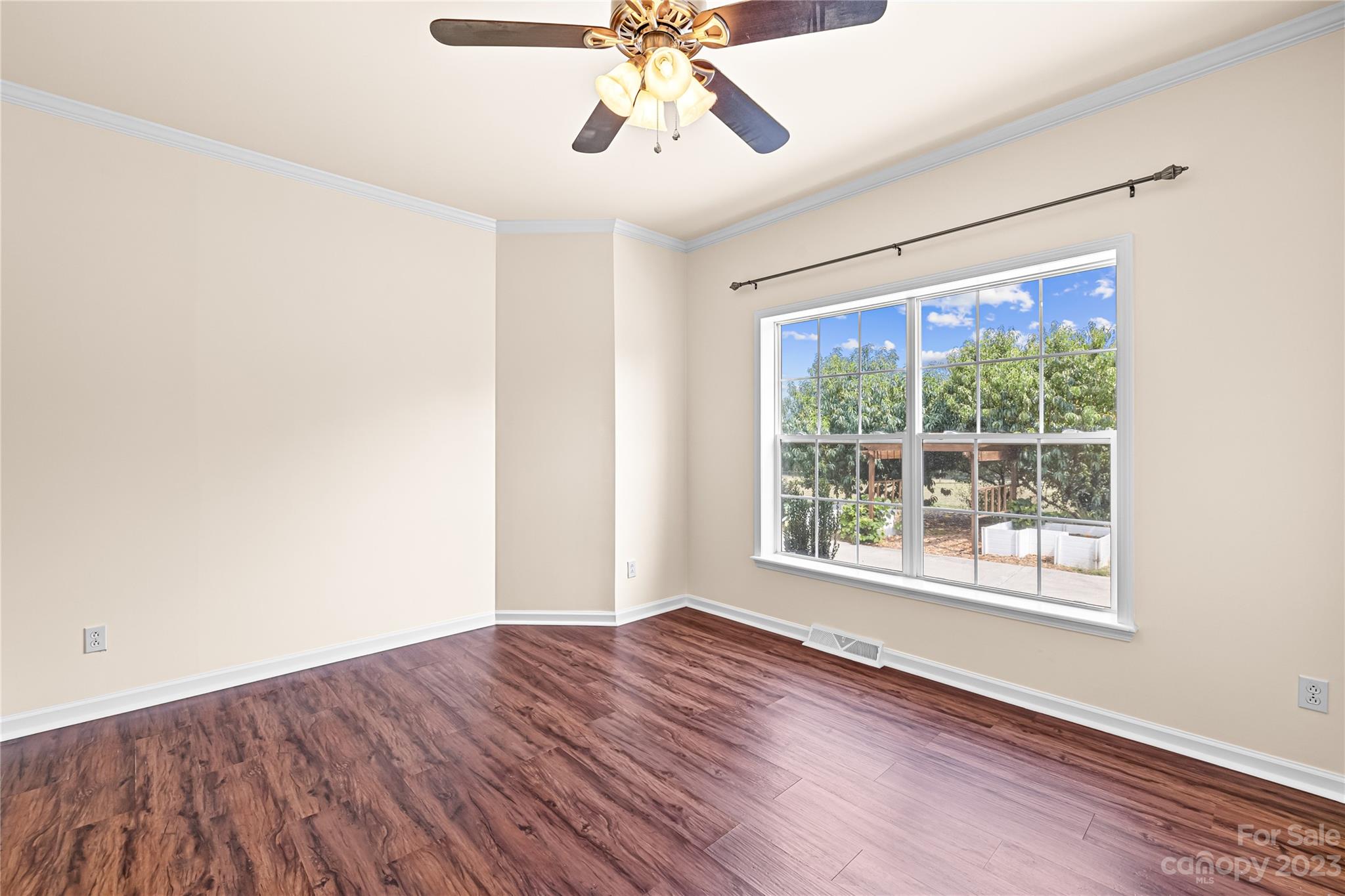 1131 Sikes Mill Road Monroe, NC 28110 - Photo 23 of 43 a view of an empty room with wooden floor and a window
