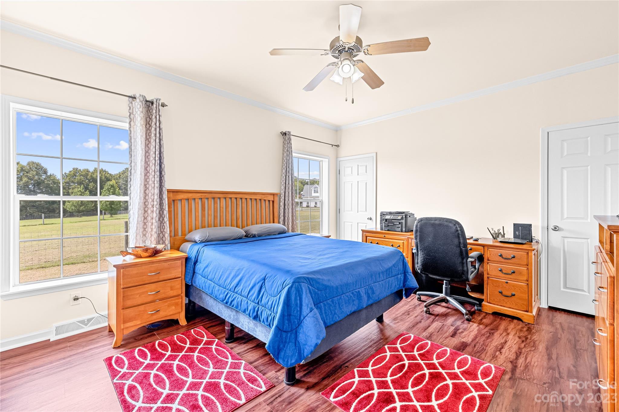 1131 Sikes Mill Road Monroe, NC 28110 - Photo 26 of 43 a bedroom with a bed and wooden floor
