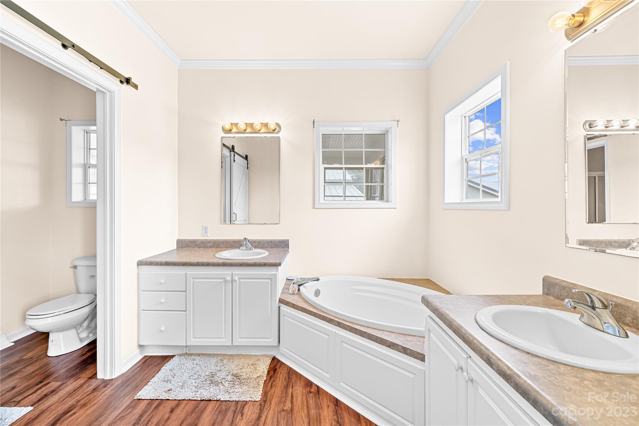 1131 Sikes Mill Road Monroe, NC 28110 - Photo 27 of 43 a bathroom with a granite countertop double vanity sink a mirror and a toilet