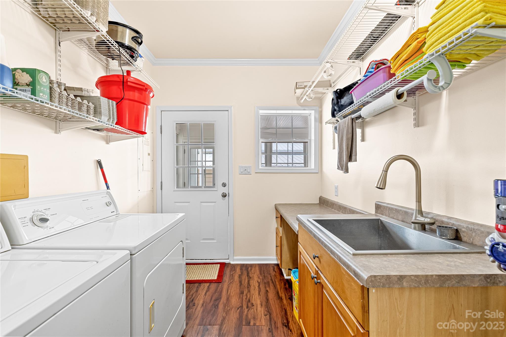 1131 Sikes Mill Road Monroe, NC 28110 - Photo 31 of 43 a kitchen that has a sink cabinets and a wooden floor