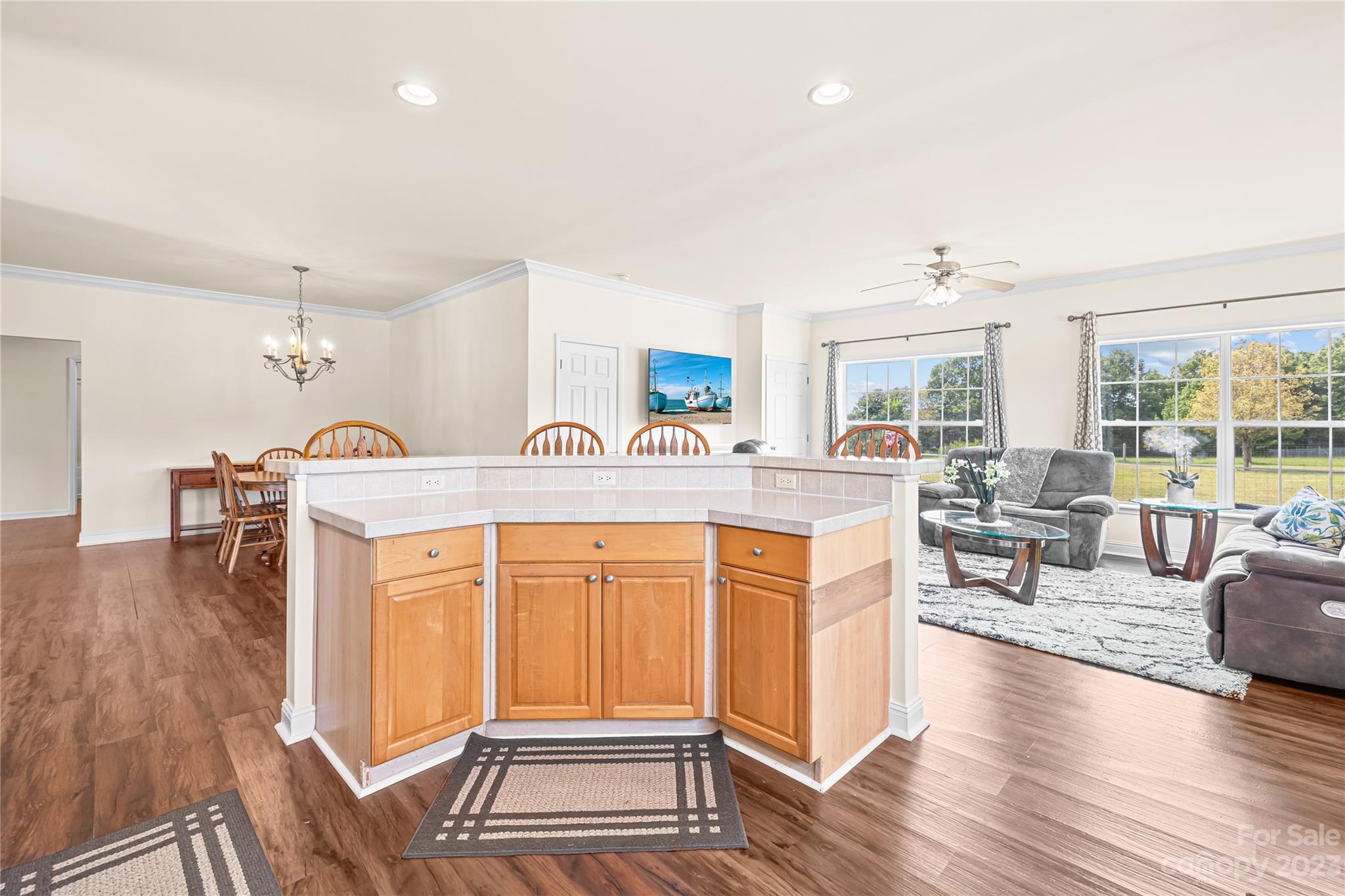 1131 Sikes Mill Road Monroe, NC 28110 - Photo 37 of 43 a living room with stainless steel appliances kitchen island granite countertop a sink and wooden floor