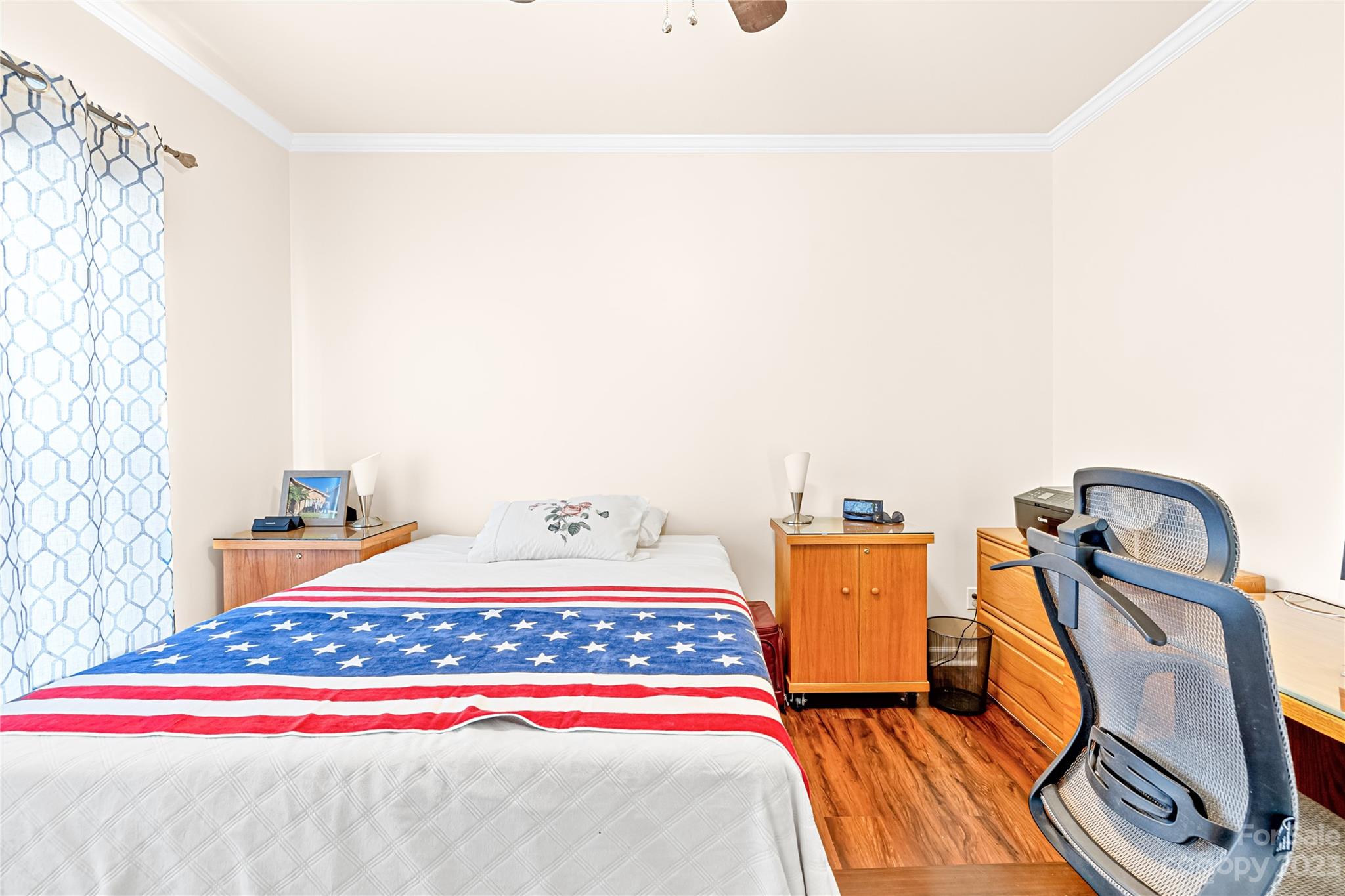 1131 Sikes Mill Road Monroe, NC 28110 - Photo 39 of 43 a bedroom with a bed and wooden floor