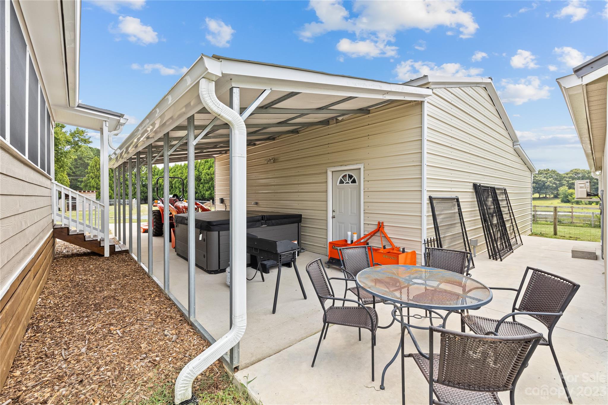 1131 Sikes Mill Road Monroe, NC 28110 - Photo 6 of 43 a view of a patio with a table and chairs and potted plants