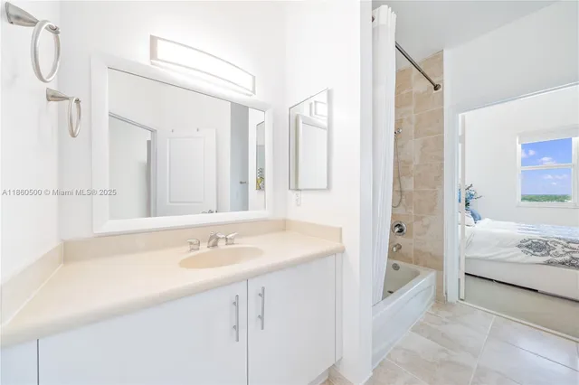 a spacious bathroom with a sink and a mirror