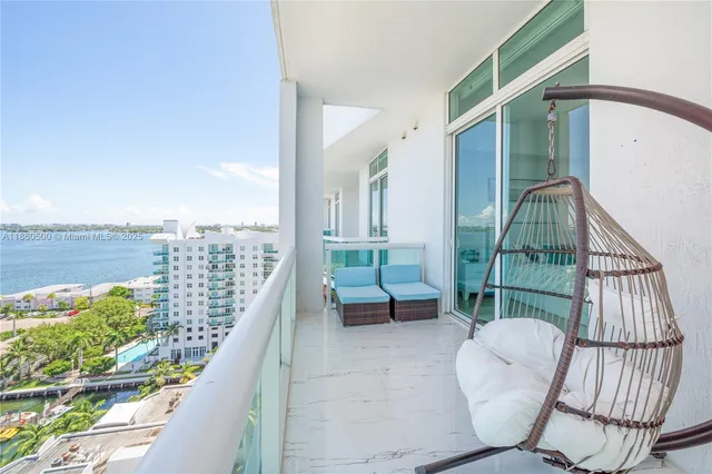 a balcony with table and chairs