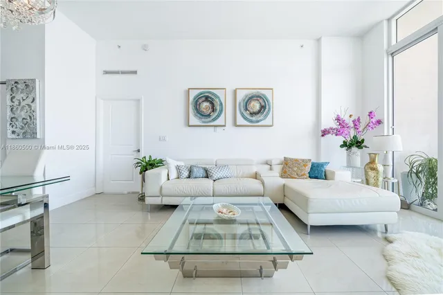 a living room with furniture and flowers