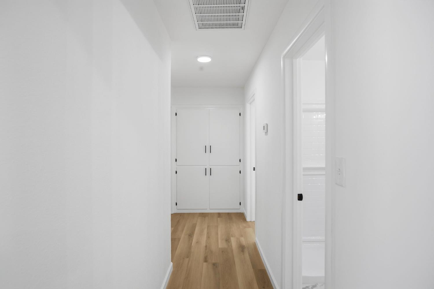 1451 Kent Way Modesto, CA 95355 - Photo 15 of 37 a view of a hallway with wooden floor