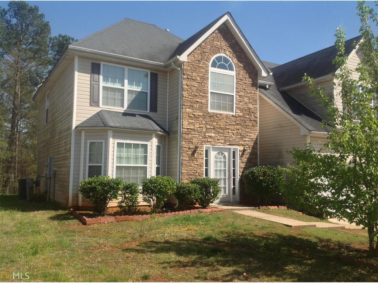 2010 Reflective Waters Road, Unit 72 Villa Rica, GA 30180 - Photo 1 of 1 a front view of a house with a yard
