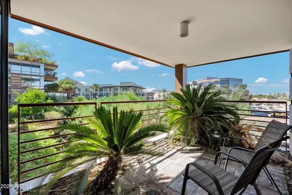 a view of a street with potted plants