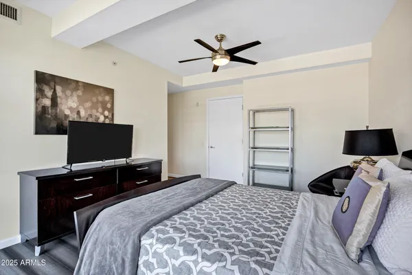 a bedroom with a bed and a flat screen tv