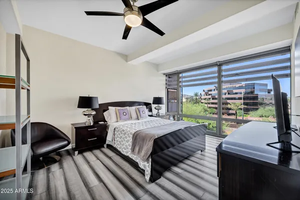 a bedroom with a bed and a large window