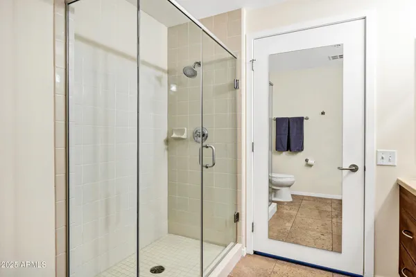 a bathroom that has a glass shower door