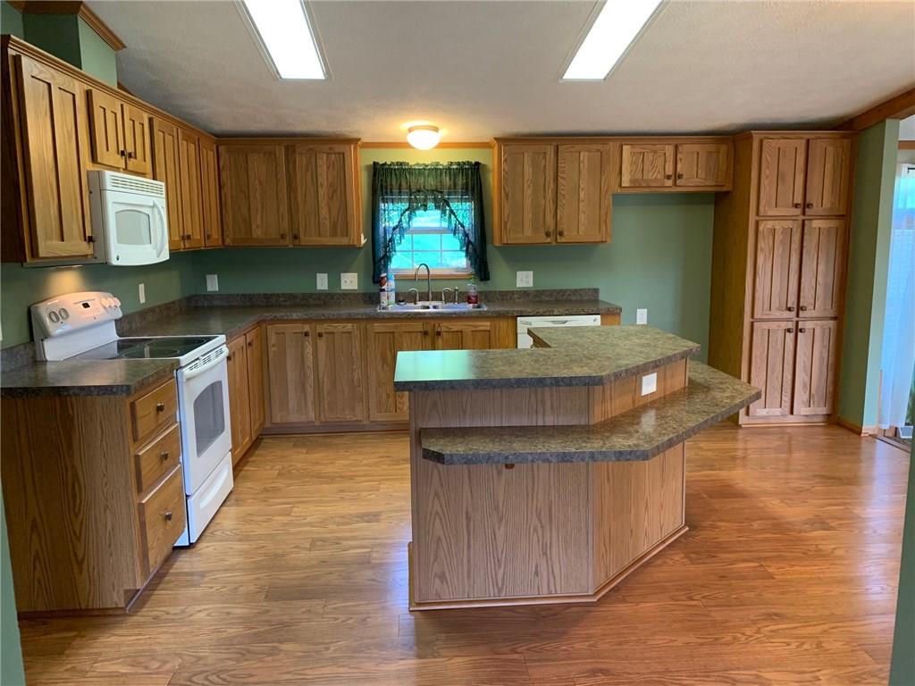 52 Willow Road Claysville, PA 15323 - Photo 7 of 25 And here is your gorgeous kitchen with vaulted ceilings and sunlights, a lot of cabinets and a nice island for extra prep space and room for the kiddos or family to hang out.