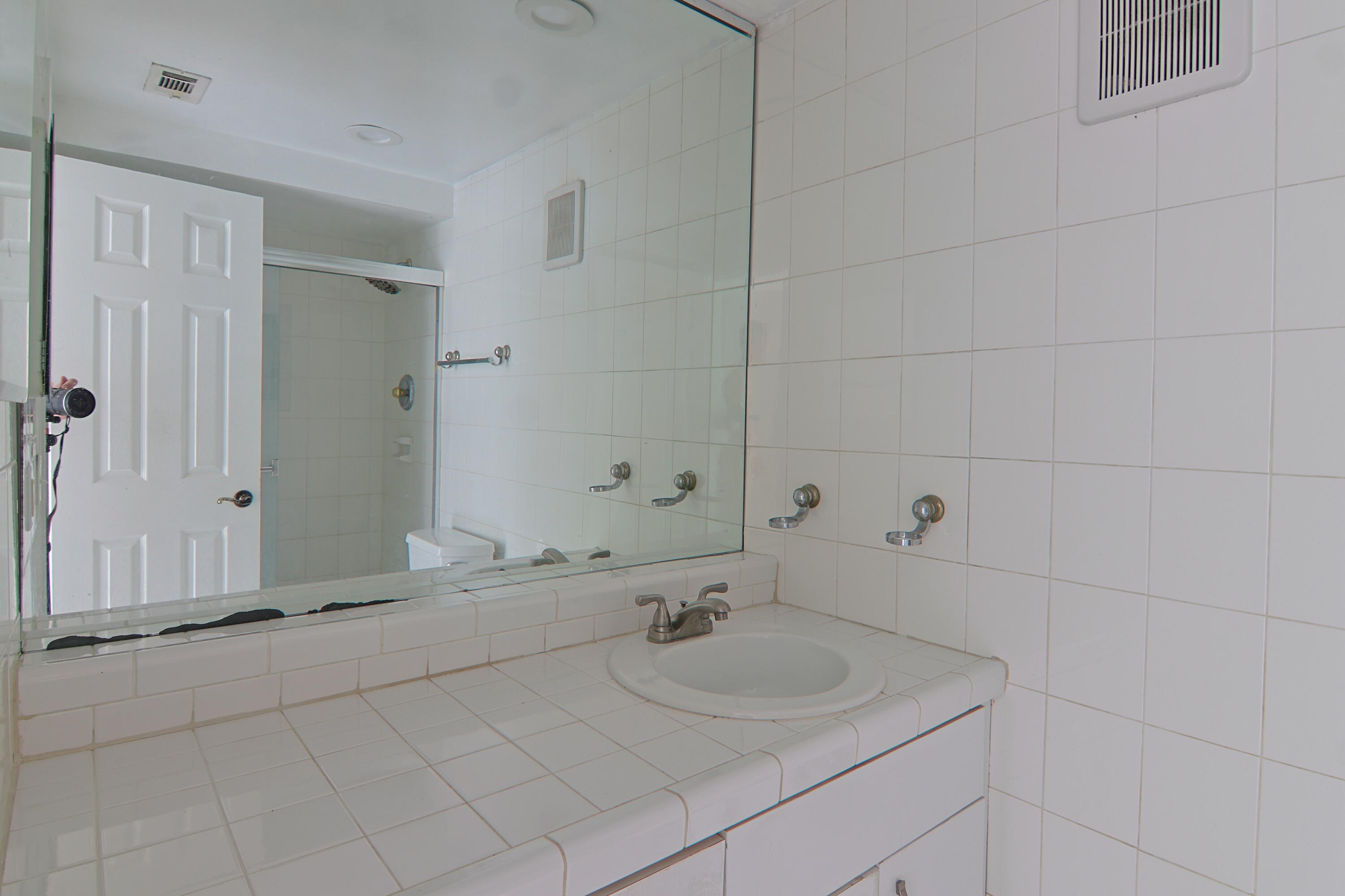 9360 Southwest 87th Avenue, Unit N8 Miami, FL 33176 - Photo 12 of 15 a bathroom with a sink and a mirror