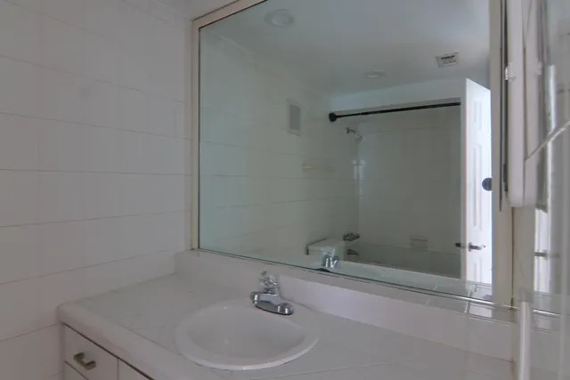 a bathroom with a sink and shower