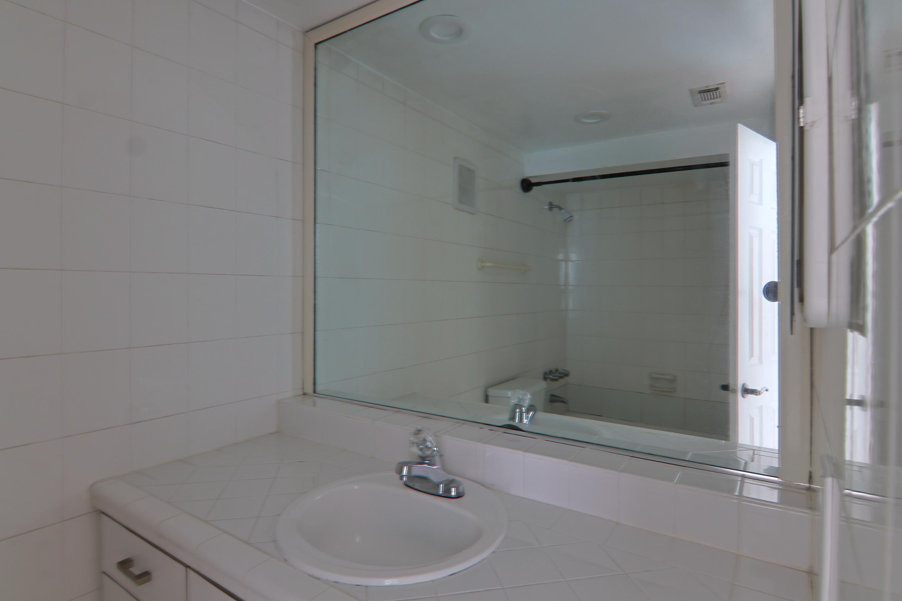 9360 Southwest 87th Avenue, Unit N8 Miami, FL 33176 - Photo 13 of 15 a bathroom with a sink and shower