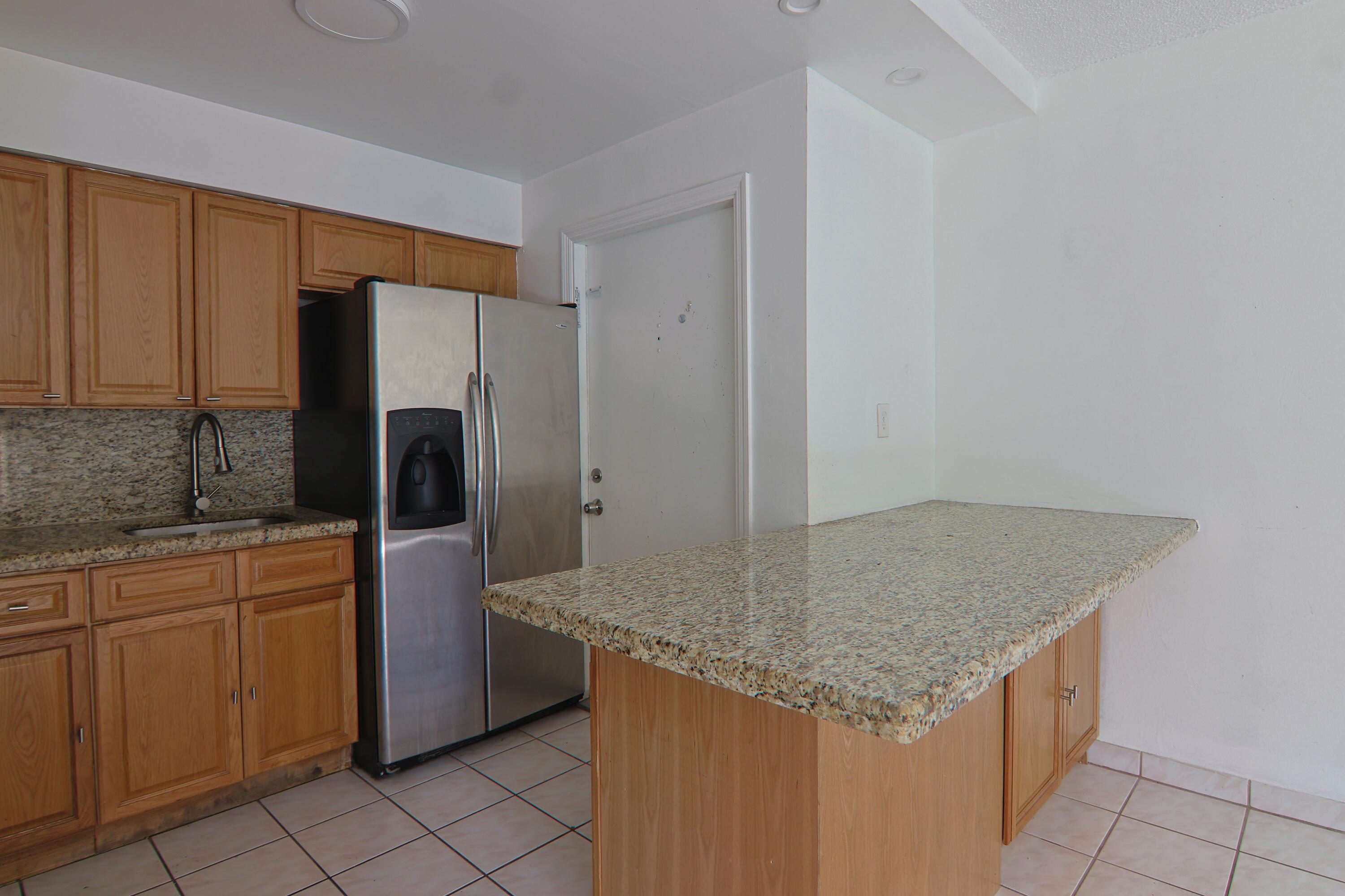 9360 Southwest 87th Avenue, Unit N8 Miami, FL 33176 - Photo 2 of 15 a kitchen with stainless steel appliances granite countertop a sink stove and refrigerator